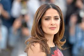The setting sunset in the background creates a romantic and dreamy setting. Salma Hayek Says Her Pet Owl Kering Likes Good Wine Vanity Fair