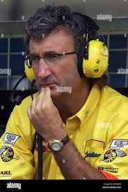 Jordan team boss Eddie Jordan takes a moment to think as he watches  practice from the pits at Silverstone ahead of the British Grand Prix Stock  Photo