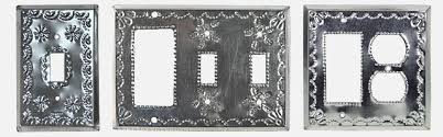 The black and white lines, shapes and marks are formed by an inlay of black stoneware into white stoneware. Mexican Natural Tin Switchplates
