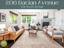 This Old North Durham Dacian delight was custom crafted by Gail Crabtree in  2017. The home boasts 4 bedrooms and an open-concept main floor. The modern  kitchen, cozy living room with fireplace