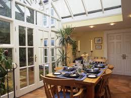 The geometric shapes painted on the hardwood floor is brightened by a massive curtained window. Country Dining Room Dining Room Decorating Ideas Lonny