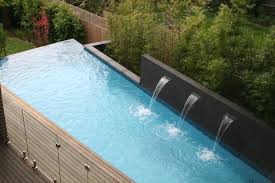 Swimming Pool With Water Feature Wall And Backdrop Of Bamboo Plantings Balwyn Display Hom Modern Backyard Landscaping Water Feature Wall Swimming Pool Designs
