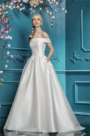 The Top Of This Bardot Dress Is Reminiscent Of The Top Of Meghan Markle S Wedding Dress The Wedding Dresses Satin Bridal Wedding Dresses Bardot Wedding Dress