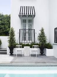 Black And White Striped Retractable Awning Mitrovski House By Greg Natale Garden Canopy Canopy Outdoor Outdoor Oasis