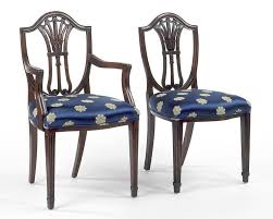 The four side chairs have a shield back design with shell, scroll, and acanthus leaf carvings. Hepplewhite Style Shield Back With Carved Tulip Design Arm Chair And S Federalist