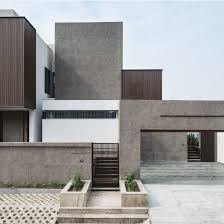 Budget house ground floor gray stone cladding white yellow colors. Sarpanch House Is Formed Of Irregylarly Stacked Boxes Hiding A Courtyard