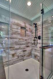 Generous Walk In Shower With Bench Seating Has Wood Look Porcelain Tile For The Surround Farmhouse Shower Shower Tile Tile Remodel