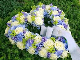 Our elegant floor basket arrangement, handcrafted by our caring florists with pristine white and blue blooms, is a tasteful gesture perfectly suited for the funeral home or memorial services. Sympathy Floral Design By Lily Beelen With White Naomi