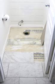 How To Prep And Tile Your Bathroom Floors Using Either Small Scale Mosaic Sheets Or Large Scale 12x24 Tiles Small Bathroom Bathroom Flooring Tile Bathroom