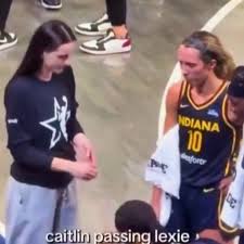 VIDEO: Caitlin Clark Was Caught On Camera Handing Fever Teammate Lexie Hull  An Odd Item During Timeout vs. Aces Full story via 🔗 in comments. 👇