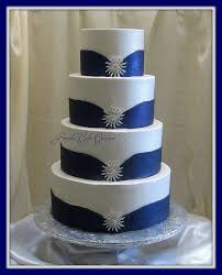 White And Blue Wedding Cake With Silver Jewelry Royal Blue Wedding Cakes Wedding Cakes Blue Wedding Cake Ribbon