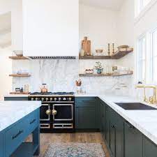 Paired with brass hardware and white quartz countertops, these blue shaker cabinets evoke a unique and vibrant feeling. Classic Transitional Contemporary Kitchen With Carrara Marble Counters Dark Green Shaker Cabinets Marble Backsplash Kitchen Kitchen Marble Kitchen Renovation