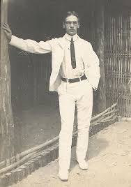 A Young Man Leaning On The Outside Wall Of A House Check Out The American Colonial Dress A White Cotton Duck Su Mens White Suit American Colonial Dress Man