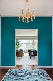 When painting your walls pure white feels too a little too stark, a misty shade of gray may be the perfect fit. Galapagos Turquoise Walls And Ikat Rug Turquoise Room Teal And Copper Bedroom Turquoise Walls
