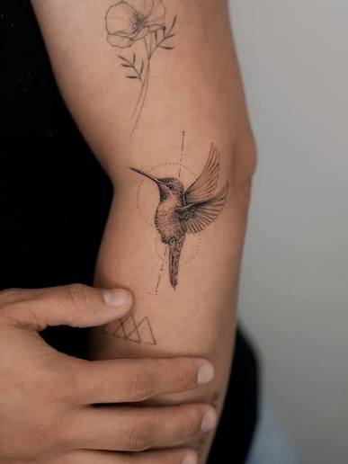 I did a small, realistic hummingbird tattoo for Andrea. The small poppy flower above it was done about two years ago, and it has healed beautifully. Thank you always for coming back!
