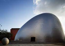 Maybe you would like to learn more about one of these? Blob Shaped Silver Building At A Japanese Music College