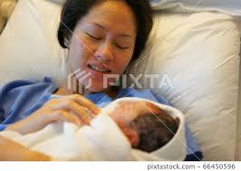 Asian Chinese woman holding her new born baby