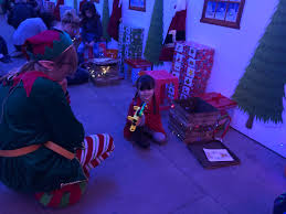 It features a formal layout design with a light grey patterned border. Becoming Honorary Elves With The Elf Adventure Challenge Out And About Mummy