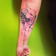 Butterfly tattoo in green and yellow with a flower on top. 50 Outstanding Watercolor Tattoos Check These Stunning Designs 2021 Updated Saved Tattoo