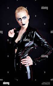 woman in latex, attractive domina on black Stock Photo - Alamy