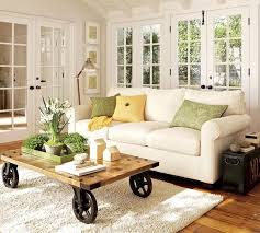It features a wooden top with a rich, finish plus stationary metal wheels. Modern Interior Design With Coffee Tables On Wheels Emphasizing Flexibility