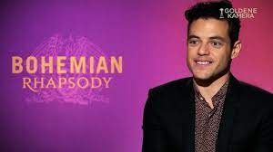 Rami malek dishes on his golden fake teeth…and then gets photobombed by mike myers! Bohemian Rhapsody Rami Malek Im Interview Youtube
