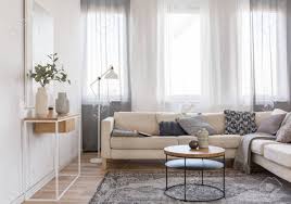 4.5 out of 5 stars. Round Coffee Table In Front Of Beige Sofa With Pillows In Bright Living Room Interior With Console Table With Flowers In Vase Stock Photo Picture And Royalty Free Image Image 121458831