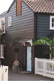 Paint finishes on your home are just as important as the colors you choose. House Off Black Exterior Eggshell House Door Blue Ground Exterior Eggshell Window Frames Fenc Exterior House Colors House Doors Colors House Exterior