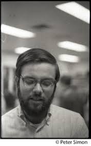John Vasquez, chair of Students for a Democratic Society at Boston  University : Posed in front of poster of a student protester