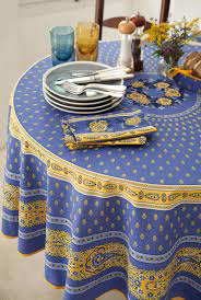 This tablecloth is beige base with a white embroidered flower at each corner and lace at 4 sides, four sides with taos taupe color full lace. French Provence Bastide Blue Yellow Acrylic Coated Tablecloth French Oilcloth Indoor Outdoor Tablecloths French Country Home Decor Gifts Marat Avignon Fabric