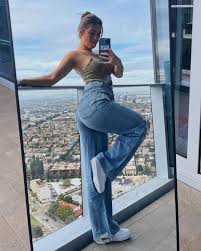 Next, rae accessorized with a fuzzy purple crossbody bag. Addison Rae Wearing Tie Dye Crop Top And Ripped Wide Leg Jeans What Stars Own