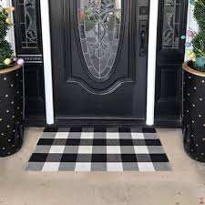 Here, buffalo check drapery creates balance between the wide tonal stripes on the walls and the two softer, more organic patterns on the area rug and upholstery. Buffalo Plaid Outdoor Rug Black White Check Carpet Door Mat Kitchen Rugs Carpets Sisal Seagrass Area Rugs