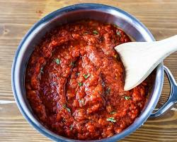 Image of Crushed tomatoes, oregano, and red pepper flakes