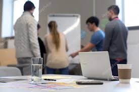 people working at flip chart business items on table stock