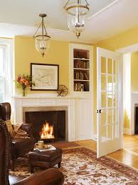 Hang a painting on an empty wall in your living room to give the space a striking visual element. 25 Cheery Ways To Use Yellow In Your Decor Yellow Living Room Paint Colors For Living Room Living Room Paint