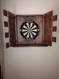 This diy dartboard cabinet will keep everyone entertained, and then stores as beautiful wall decor when not in use! Finished Dart Board Cabinet Dart Board Cabinet Dart Board Dartboard Setup