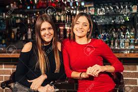 Two beautiful brunettes in one bed, playing each other, what could be more hot and sexy? Two Beautiful Brunette Women Sitting At The Bar Have Fun Smile Stock Photo Picture And Royalty Free Image Image 68198086