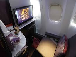 The wall doesn't quite reach the ceiling so it isn't fully enclosed. Qatar Airways Business Class Review Does Its Qsuite Live Up To The Hype