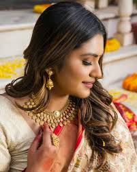 In her eyes, a thousand dreams shine, Adorned in jewels, a legacy divine.  Each piece whispers stories untold, Of love, of strength, of traditions  old. Her steps echo grace, her smile a