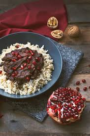 The main part of the stew is made with crushed walnuts, onions and pomegranate concentrate. Persian Pomegranate And Walnut Stew Fesenjoon