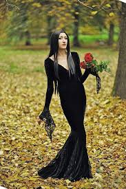 27 Halloween Costume Ideas To Dress Like Your Favorite Badass Woman Black Dress Halloween Costume Cool Girl Costumes Morticia Addams Dress