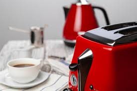 The reflective surface sends light bouncing about the space and works well with gray concrete countertops and flooring. Premium Photo Close Up Of Red Kitchen Appliances On Kitchen Table