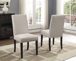 You may want use armless dining side chairs and add two coordinating dining chairs with arms at the head and foot of the table to create a more formal. Amazon Com Roundhill Furniture Biony Tan Fabric Dining Chairs With Nailhead Trim Set Of 2 Chairs