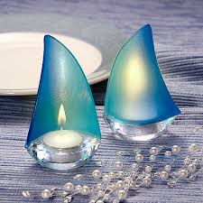 These glass candle holders each have a different design. 3 X 5 Glass Blue Regatta Sailboat Votive Candle Holder Favors