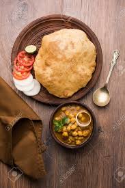 Although it is known as a typical punjabi dish, there are varied claims around the origin of dish. Chole Bhature Or Chick Pea Curry And Fried Puri Served In Terracotta Stock Photo Picture And Royalty Free Image Image 102976671