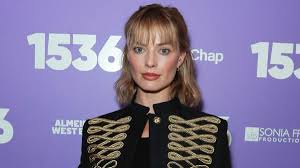 Margot Robbie’s Lacy Doen Top Hangs on for Dear Life With Micro Miniskirt