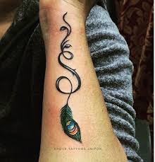 Suitable for both men and women; S Letter Tattoo With Peacock Feather Done At Xpose Tattoos Jaipur