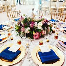 Fantasy Wedding Decor Gold Charger Plates Gold Chiavari Chairs White Linens And Deep Blue Napkins Allincl Catering Design Wedding Decorations Blue Napkins