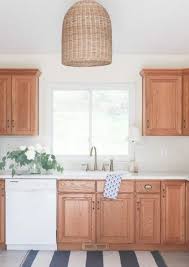 The leather brown floors paired with the oslo gray cabinets work great in this kitchen because of its abundant natural lighting. 7 Ideas To Steal From Rental Kitchens Rocking Their Oak Wood Cabinets Honey Oak Cabinets Oak Kitchen Oak Kitchen Cabinets