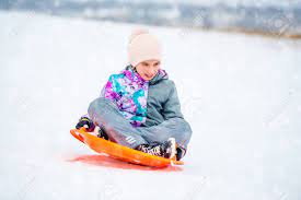 Use them in commercial designs under lifetime, perpetual & worldwide rights. Girl Sliding Down The Hill On Saucer Sled Stock Photo Picture And Royalty Free Image Image 96764654